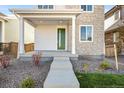 Inviting front porch with stone and siding exterior at 21224 E 63Rd Dr, Aurora, CO 80019