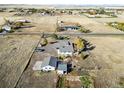Aerial view of property showing house, outbuildings, and surrounding land at 54686 E Bobcat Ln, Strasburg, CO 80136