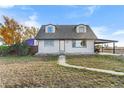 House exterior showcasing front yard and carport at 54686 E Bobcat Ln, Strasburg, CO 80136