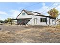 Rear view of house with carport and rural setting at 54686 E Bobcat Ln, Strasburg, CO 80136
