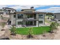 Backyard view of two-story home with balcony at 6196 Oxford Peak Ln, Castle Rock, CO 80108