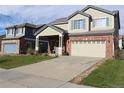 Two-story house with a covered porch and landscaping at 15171 E 118Th Ave, Commerce City, CO 80603