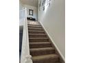 Carpeted staircase with simple white railing at 15171 E 118Th Ave, Commerce City, CO 80603