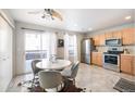 Eat-in kitchen with stainless steel appliances and access to a deck at 7862 S Kalispell Cir, Englewood, CO 80112