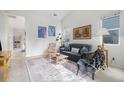 Bright living room featuring a comfy couch and large windows at 20123 E Ithaca Pl, Aurora, CO 80013