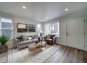 Bright living room featuring modern furniture and hardwood floors at 12916 E 103Rd Ave, Commerce City, CO 80022