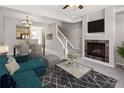 Living room with fireplace, teal couch, and dining area at 7874 W 55Th Ave, Arvada, CO 80002