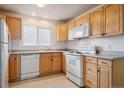 Bright kitchen with light wood cabinets and appliances at 2715 W 86Th Ave # 21, Westminster, CO 80031