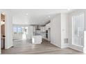 Modern white kitchen with island and stainless steel appliances at 1289 Penner Dr, Erie, CO 80026