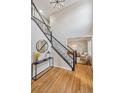 Elegant entryway with hardwood floors, a staircase with iron railing, and a console table at 9939 Hawthorne St, Highlands Ranch, CO 80126