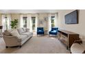 Living room with neutral colored couch and blue accent chairs at 1150 Inca St # 27, Denver, CO 80204