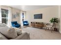 Living room with neutral colored couch and blue accent chairs at 1150 Inca St # 27, Denver, CO 80204