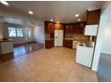 Bright kitchen features wood cabinets, tile floors, and a view into the living area at 13430 Green Cir, Broomfield, CO 80020