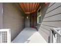 Covered patio area with a red door leading into the home at 537 S Upham Ct, Lakewood, CO 80226