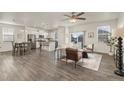 Open living space with hardwood floors, a ceiling fan, and neutral decor at 109 Racer St, Bennett, CO 80102