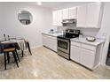 Bright, updated kitchen with white cabinets and marble countertops at 9050 Cody Ct, Broomfield, CO 80021