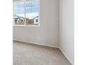 Bright bedroom with neutral carpeting and a large window at 827 Goodrich Peak St, Erie, CO 80516