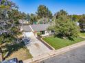 Ranch style home with well-manicured lawn and driveway at 9927 E 7Th Ave, Aurora, CO 80010