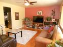 Living room with hardwood floors, leather sofas, and built-in shelving at 12484 E Alaska Ave, Aurora, CO 80012