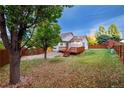 Spacious backyard with a deck, providing ample outdoor space at 8782 Troon Village Pl, Lone Tree, CO 80124