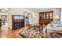 Bright living room with hardwood floors, comfy seating, and built-in shelving at 8341 Mason Cir, Westminster, CO 80031