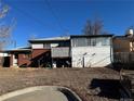 Home's back features a deck, sunroom addition, and a spacious yard at 3073 Zion St, Aurora, CO 80011