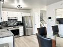 Modern kitchen with stainless steel appliances and granite countertops at 17413 E Louisiana Ave, Aurora, CO 80017