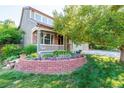 House exterior with landscaped yard and brick planter at 3893 Mallard St, Highlands Ranch, CO 80126