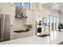 Modern kitchen with stainless steel appliances and white cabinets at 3907 Piney Grove St, Evergreen, CO 80439