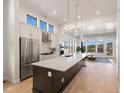 Modern kitchen with stainless steel appliances, an island, and plenty of cabinet space at 3907 Piney Grove St, Evergreen, CO 80439