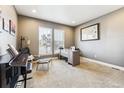 Bright home office with large windows, desk, and comfortable seating at 8551 Orchard Way, Arvada, CO 80007