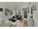 Cozy living room featuring a leather couch, coffee table, and large windows at 19418 E Arcaro Creek Pl, Parker, CO 80134