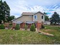Landscaped backyard with patio and shade sails at 20175 Edinborough Pl, Parker, CO 80138