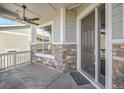 Front porch with stone accents and ceiling fan at 22002 E Allenspark Dr, Aurora, CO 80016