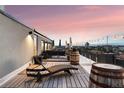 Private rooftop deck with city views and lounge chair at 669 N Washington St # 901, Denver, CO 80203
