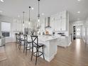 Modern kitchen with white cabinets and large island at 6803 Canyonpoint Rd, Castle Pines, CO 80108