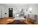 Living room with hardwood floors, comfy seating, and natural light at 1283 Trenton St, Denver, CO 80220