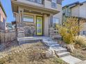 Inviting front porch with stonework and two chairs, steps leading to the entrance at 6052 N Malta St, Aurora, CO 80019