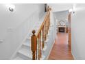 Bright, open staircase with wood railing leading to the upper level at 4218 Owens St, Wheat Ridge, CO 80033