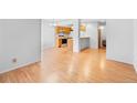 Light-filled dining area with wood floors and kitchen access at 4218 Owens St, Wheat Ridge, CO 80033