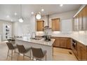 Modern kitchen with island, stainless steel appliances, and light wood cabinets at 1739 W 166Th Ave, Broomfield, CO 80023