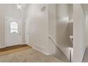 Bright entryway with staircase and carpeted floor at 14215 E Marina Dr, Aurora, CO 80014