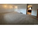 Spacious living room with carpet and access to other rooms at 8632 E Layton Ave, Denver, CO 80237