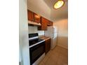Kitchen features wood cabinets, a white refrigerator, and a black stove at 467 S Memphis Way # 17, Aurora, CO 80017