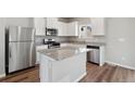 Modern kitchen with stainless steel appliances and an island at 7238 Arkansas St, Frederick, CO 80530