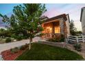 Inviting front entrance with stone accents, a covered porch and well-manicured landscaping at 24610 E Wyoming Cir, Aurora, CO 80018