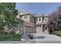 Two-story home with brick and siding exterior, showcasing its curb appeal at 2599 S Jebel Way, Aurora, CO 80013