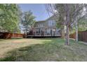 View of the home's backyard, showcasing the deck and landscaping at 2599 S Jebel Way, Aurora, CO 80013