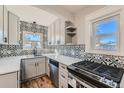 Updated kitchen with modern gray cabinets and black and white tile at 101 S 11Th Ave, Brighton, CO 80601