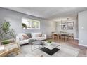 Bright living room with contemporary furniture and wood-look floors at 50 E Highline Cir # 104, Centennial, CO 80122